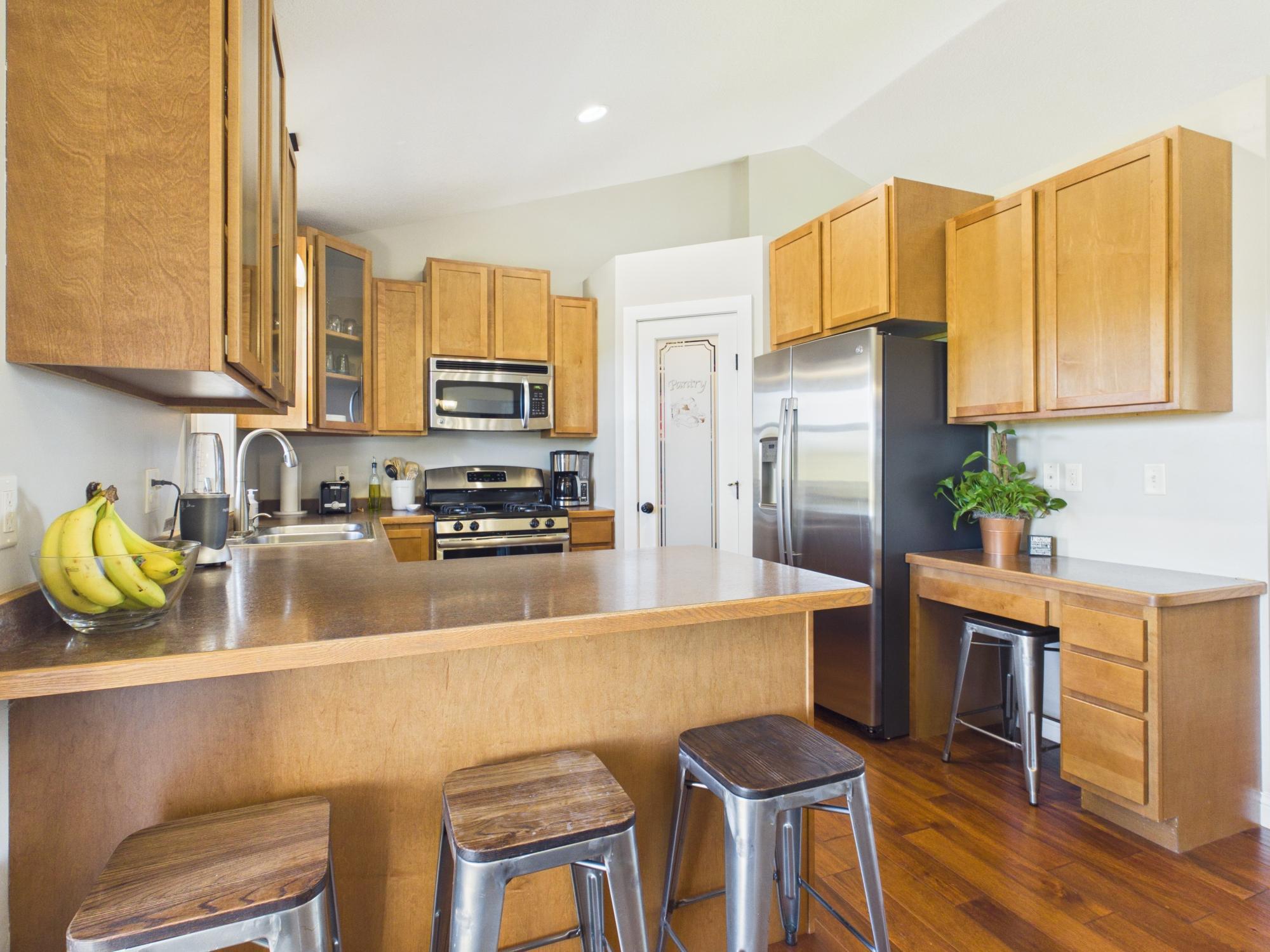 Kitchen offers a pantry, desk and lots of cabinets.