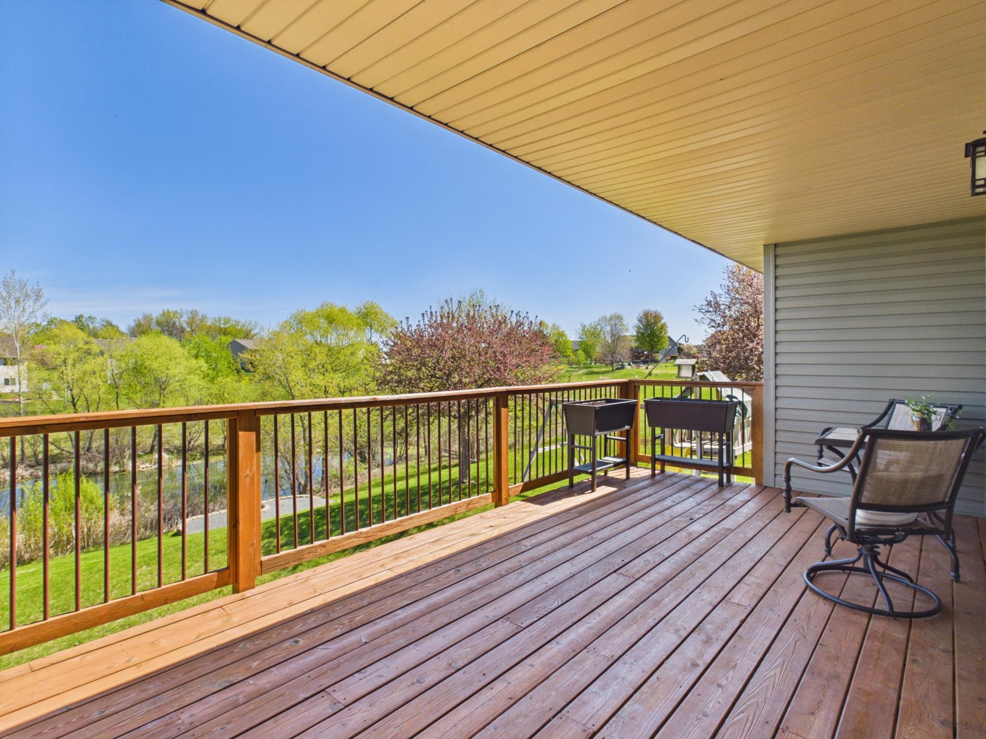 The covered deck overlooks the backyard with a new firepit. Enjoy nature year-round.