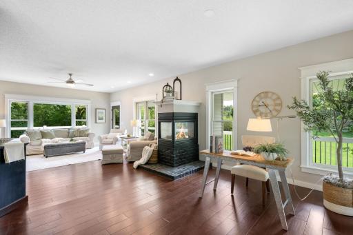 Spacious, light-filled family room. featuring expansive windows. connecting the adjoining living/office space.