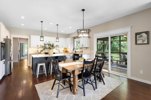Open kitchen and dining area, a spacious center island with seating, and easy access to the screened porch—perfect for everyday living and entertaining.