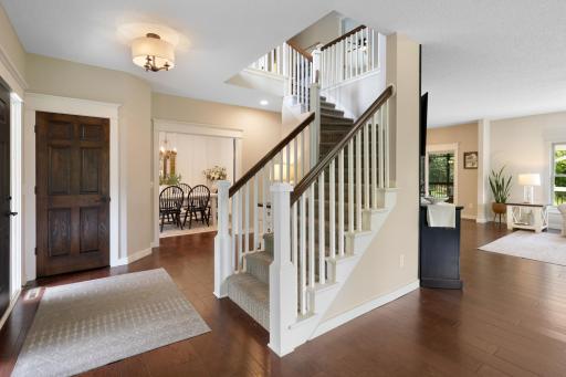 Dramatic enameled spindle staircase leading to the upper level.