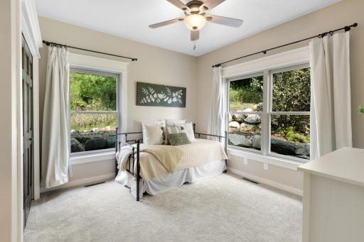 Rare main-level bedroom/office featuring oversized windows, abundant natural light, and peaceful views of the surrounding acreage.