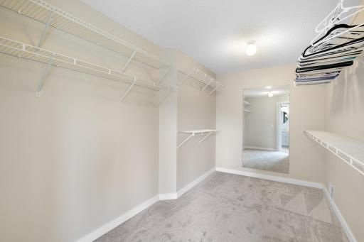 Oversized primary walk-in closet offering exceptional storage with abundant hanging and shelving space.