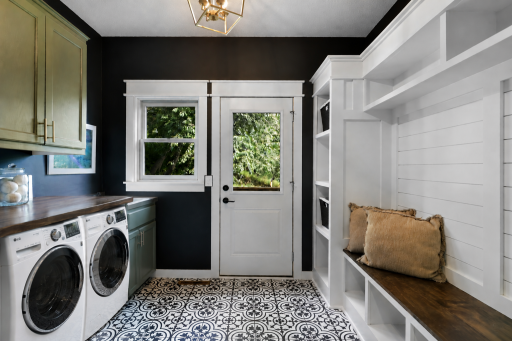Beautiful updated mudroom/laundry area. Washer and dryer not included with the home. Added to photo with AI.