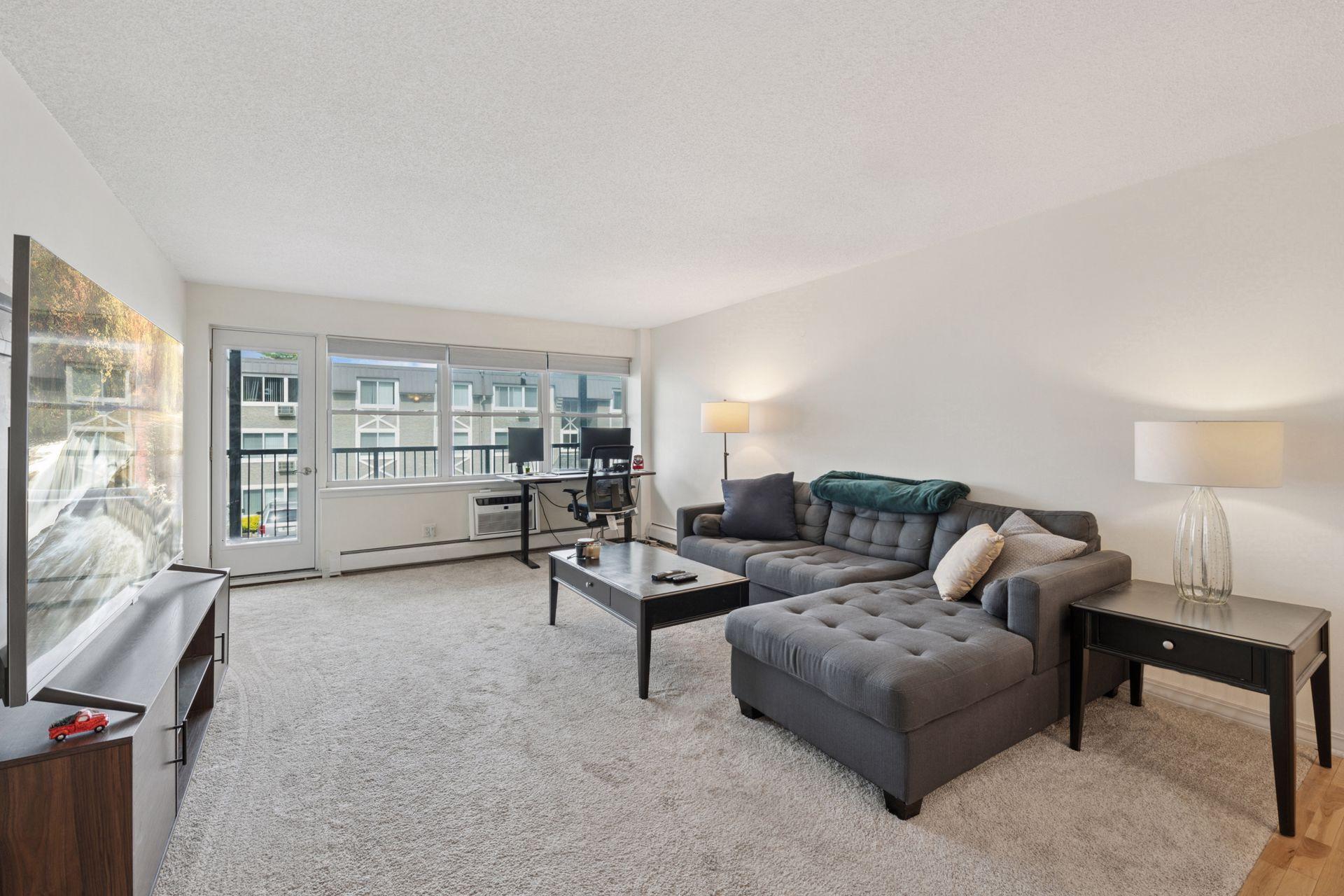 Spacious, sun-filled living room just steps from Lake Bde Maka Ska! This open-concept layout offers oversized windows, private balcony access, and flexible space perfect for a home office or relaxing retreat. Located in a secure building near bike tr