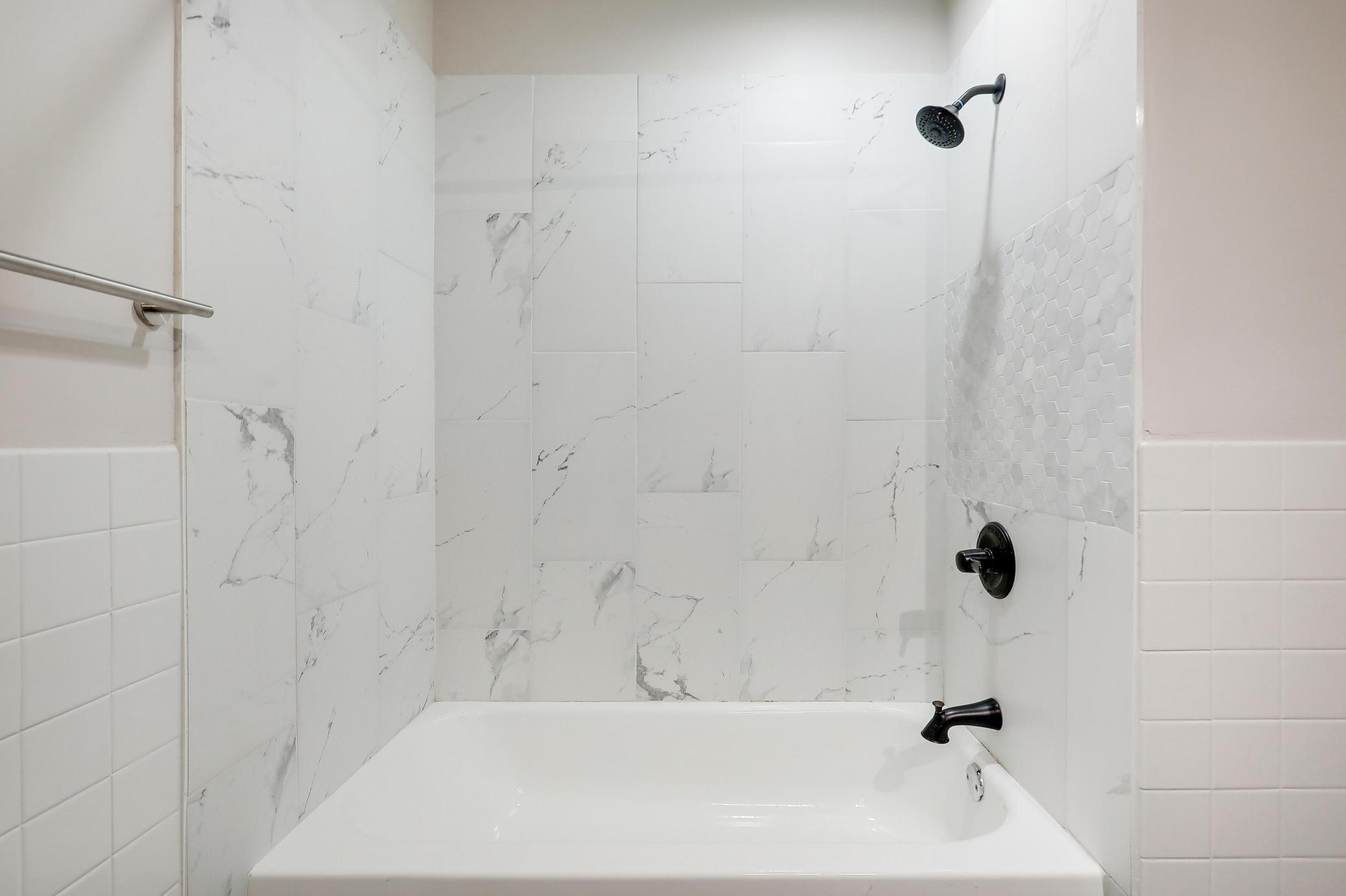 Upper level full bath with updated tile and fixtures.