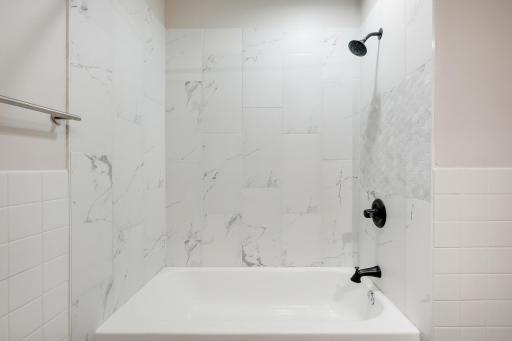 Upper level full bath with updated tile and fixtures.