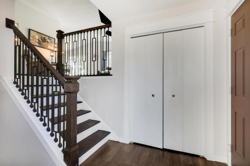 Spacious foyer with convenient coat closet and stunning new wrought iron railing.