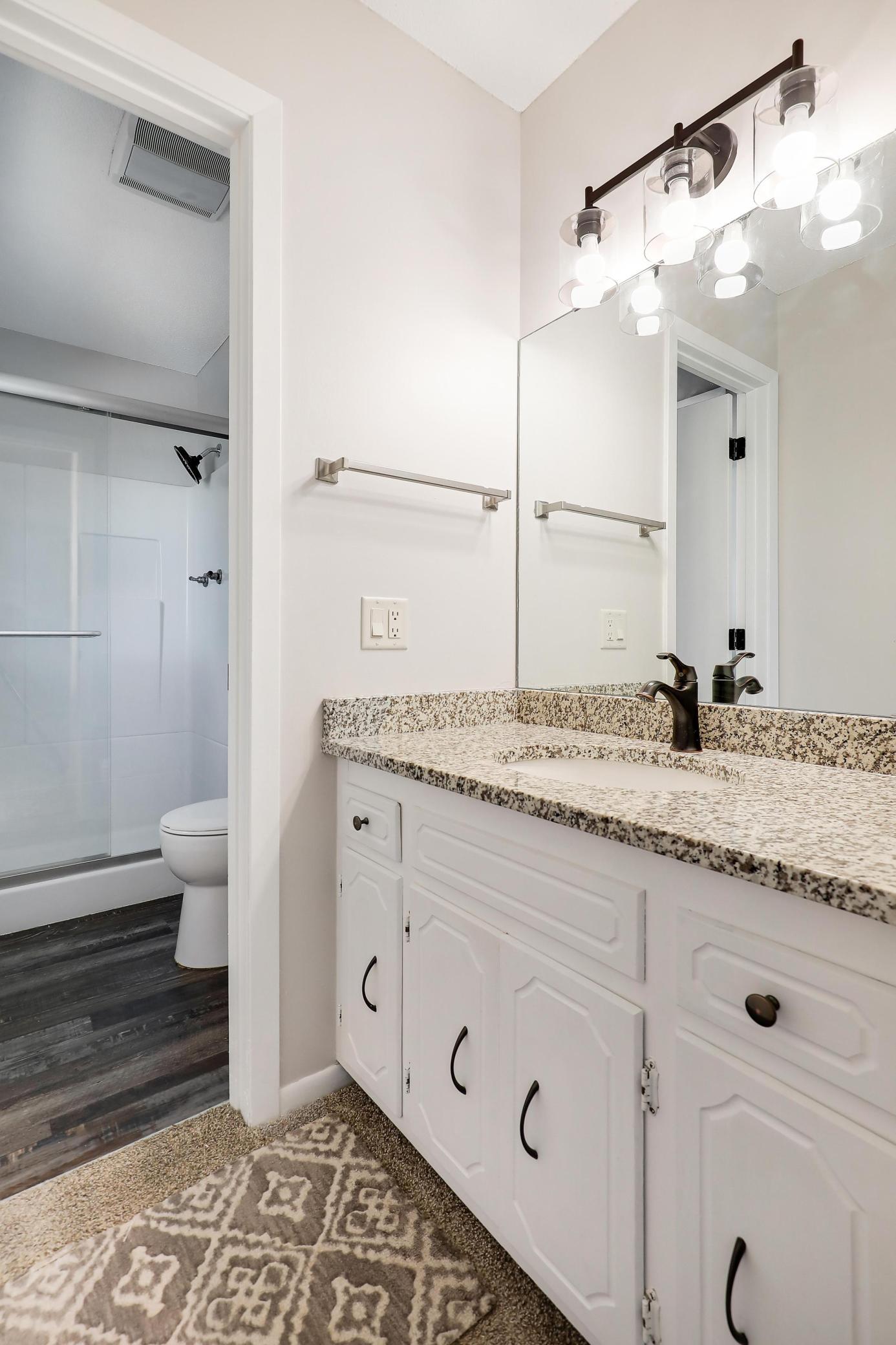 The primary bath features stone countertops and updated flooring.