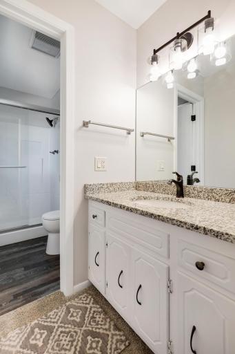 The primary bath features stone countertops and updated flooring.