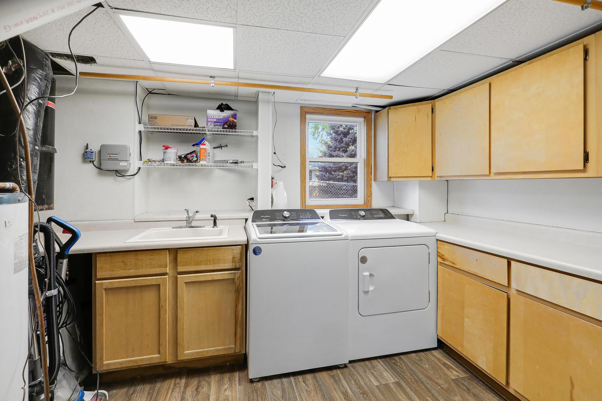 The lower level includes a laundry area complete with a utility sink for added convenience.