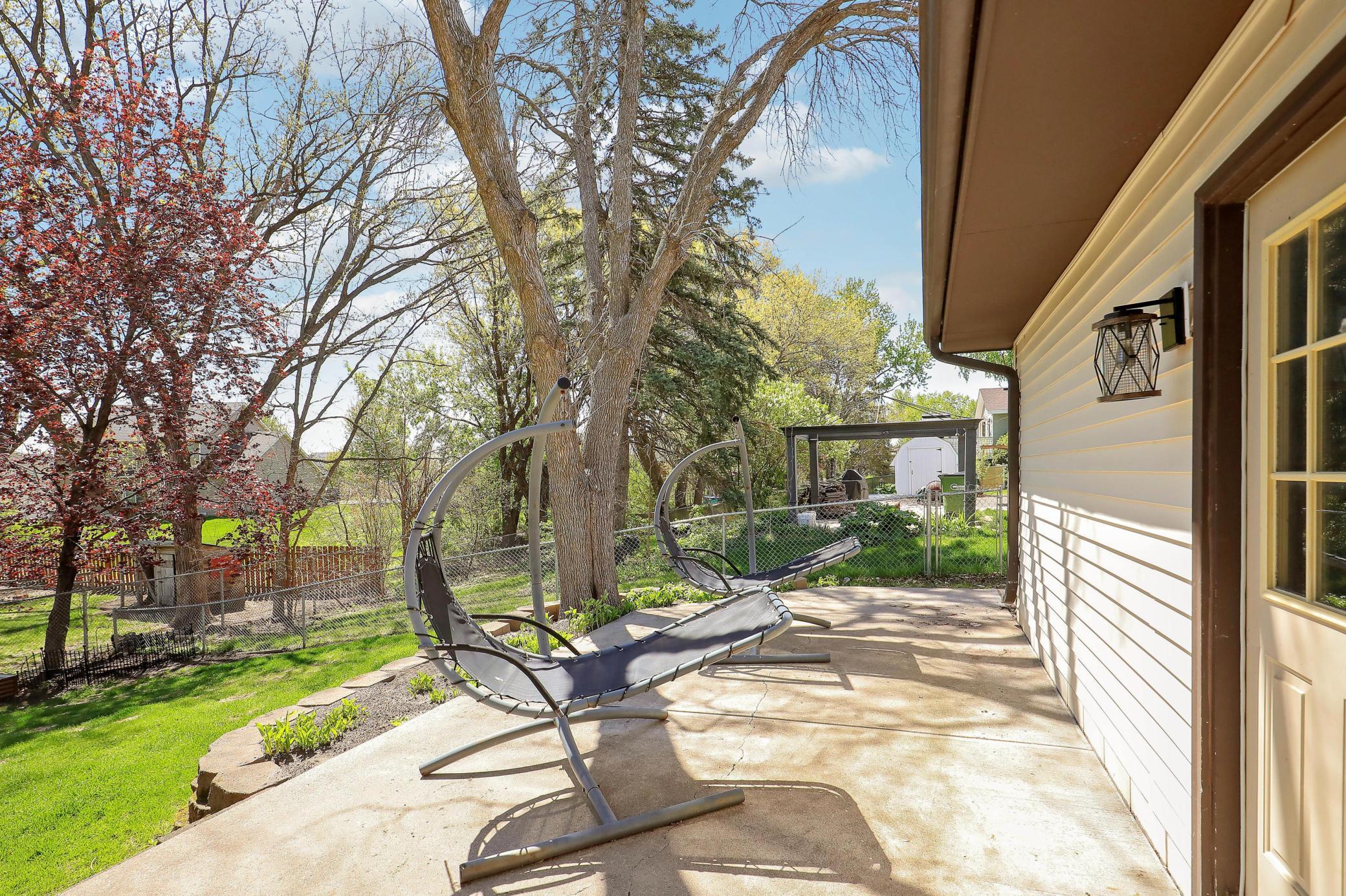 A concrete patio off the service door from the garage provides a great space for grilling and outdoor cooking.