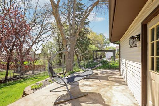 A concrete patio off the service door from the garage provides a great space for grilling and outdoor cooking.