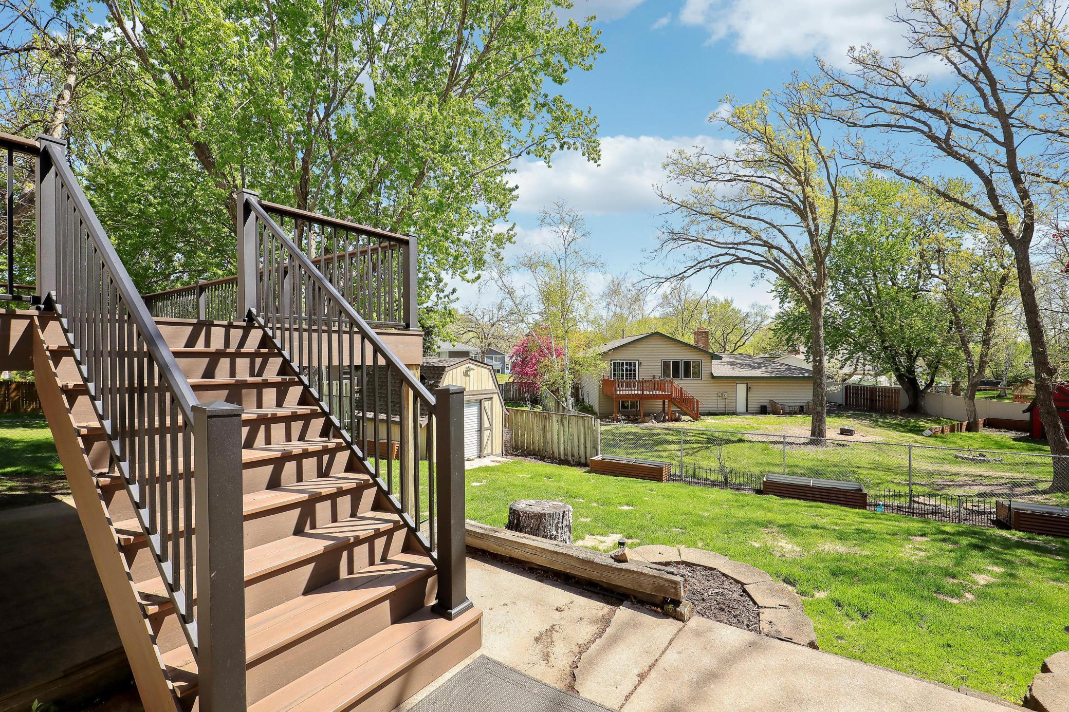 The backyard is enclosed with a chain-link fence, offering both openness and defined yard space.