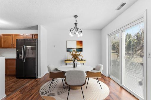 This welcoming dining area has been virtually staged to give you an idea of what the space could look like... perfect for meals, friends, conversations and get togethers.