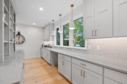 Open Prep Kitchen w/ addtâl custom cabinetry, beverage fridge, pocket Office & floating shelving