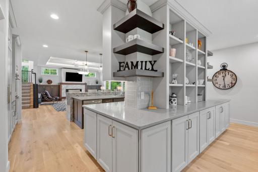 Open Prep Kitchen w/ addtâl custom cabinetry, beverage fridge, pocket Office & floating shelving