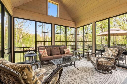 Exceptional 3-season Porch w/ cathedral ceiling, SunSpace windows & Trex flooring overlooks private backyard w/ mature trees,