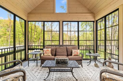 Exceptional 3-season Porch w/ cathedral ceiling, SunSpace windows & Trex flooring overlooks private backyard w/ mature trees,