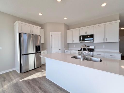 PHOTO OF A DIFFERENT HOME WITH SIMILAR PLAN. FINISHES MAY VARY.