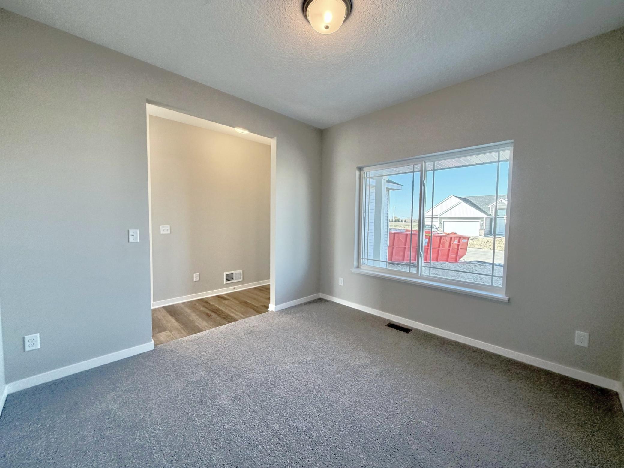 PHOTO OF A DIFFERENT HOME WITH SIMILAR PLAN. FINISHES MAY VARY. Main Floor Flex Room.