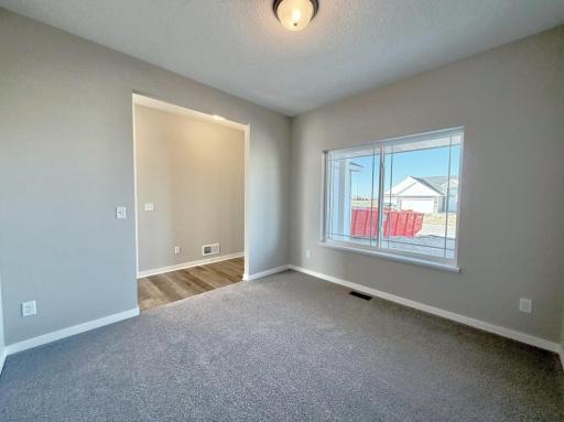 PHOTO OF A DIFFERENT HOME WITH SIMILAR PLAN. FINISHES MAY VARY. Main Floor Flex Room.
