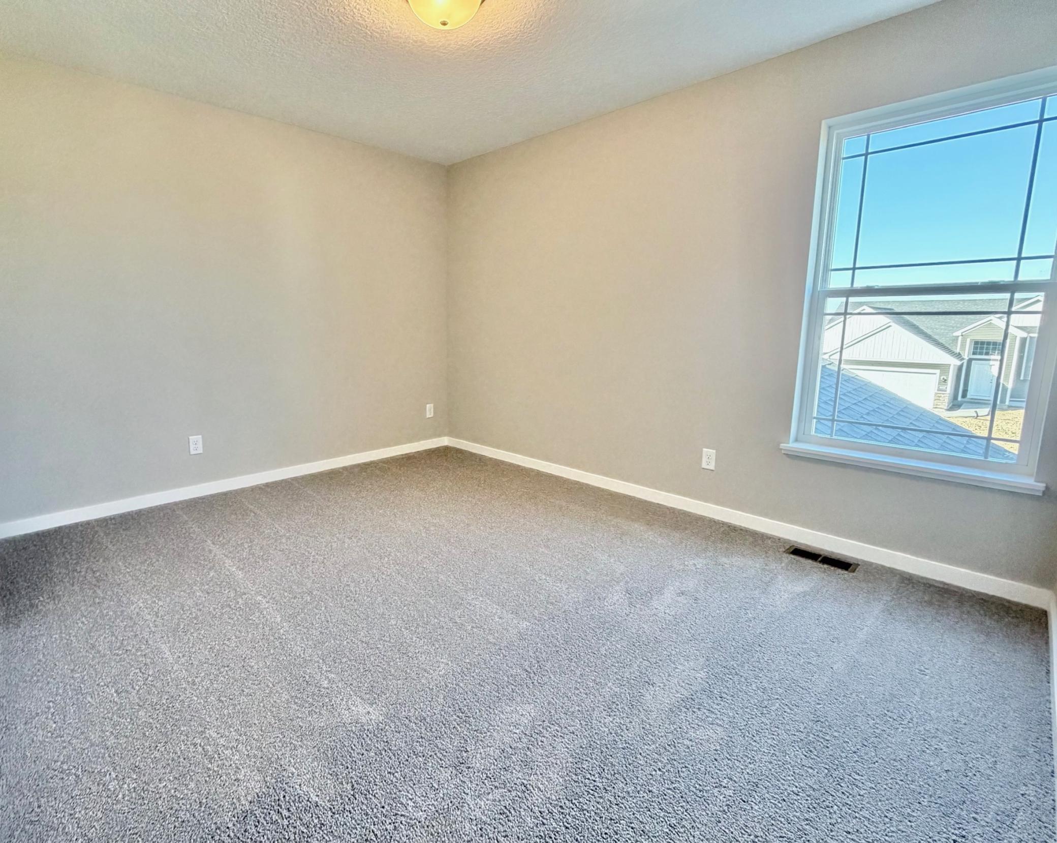 PHOTO OF A DIFFERENT HOME WITH SIMILAR PLAN. FINISHES MAY VARY. Bedroom 2.