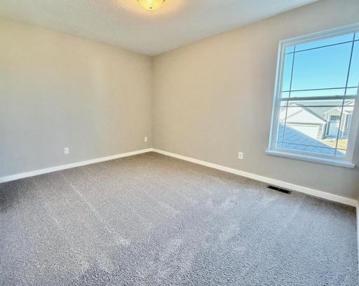 PHOTO OF A DIFFERENT HOME WITH SIMILAR PLAN. FINISHES MAY VARY. Bedroom 2.