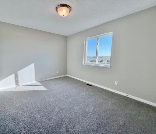 PHOTO OF A DIFFERENT HOME WITH SIMILAR PLAN. FINISHES MAY VARY. Bedroom 4 features a Walk-in Closet.