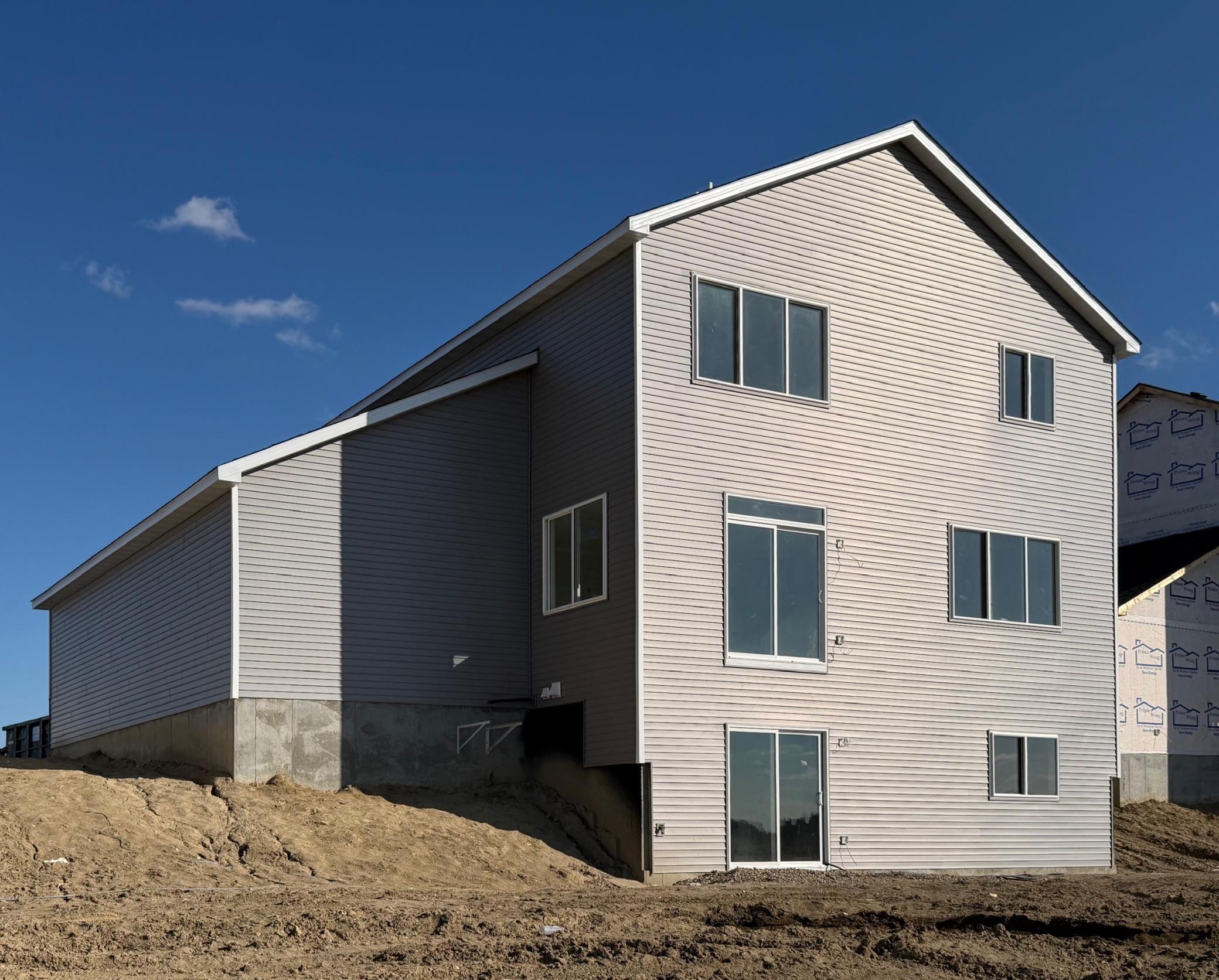 3171 Jandura Ave NE- Rear elevation features a walkout lower level to spacious backyard.