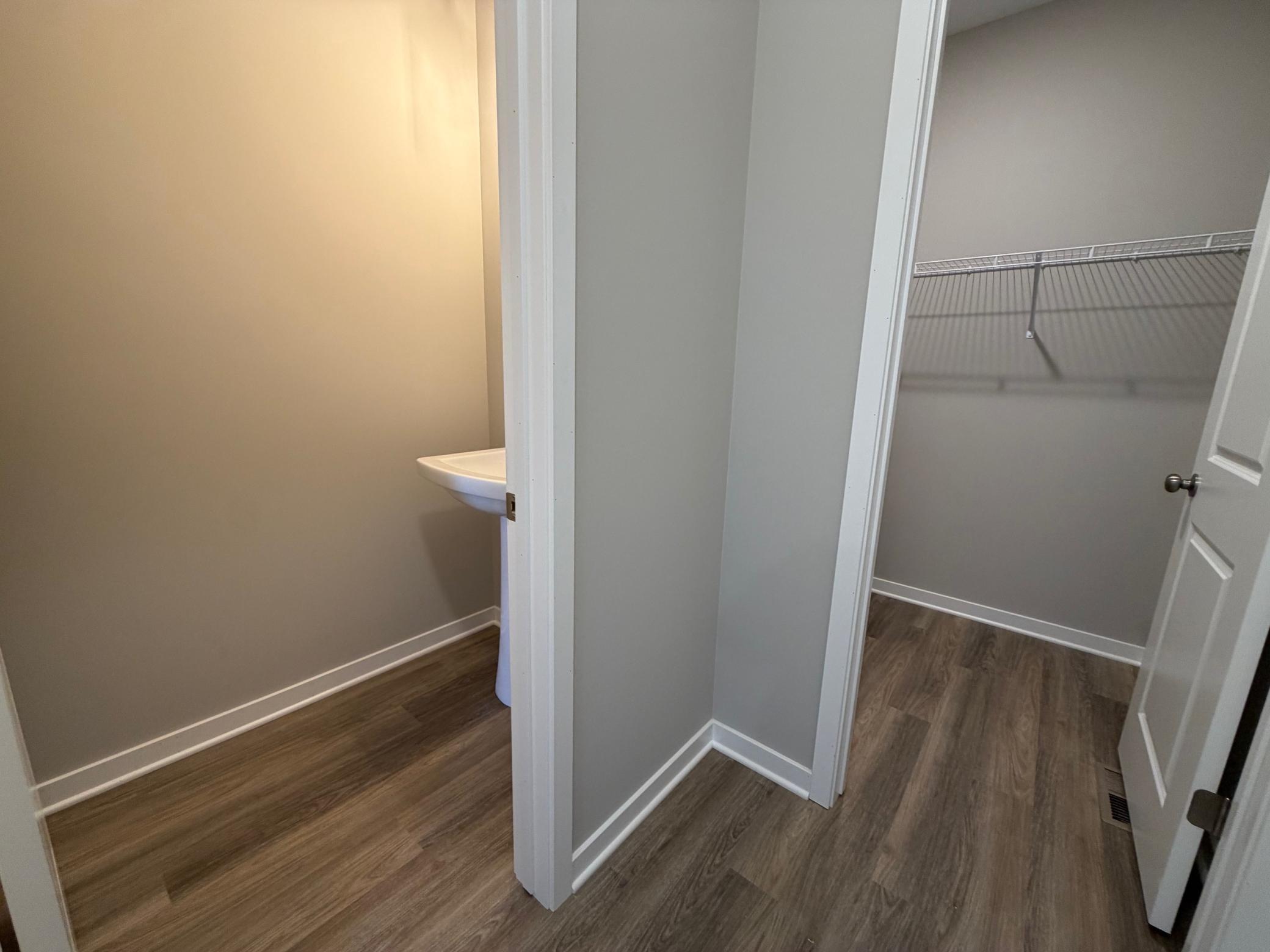 PHOTO OF A DIFFERENT HOME WITH SIMILAR PLAN. FINISHES MAY VARY. Main Floor Half Bath and Mudroom Walk-in Closet.
