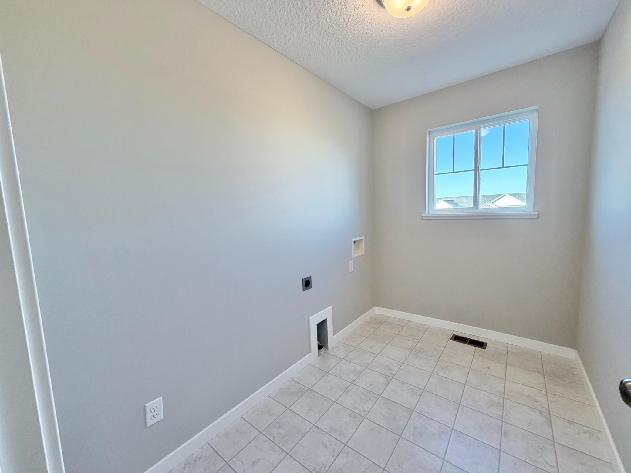 PHOTO OF A DIFFERENT HOME WITH SIMILAR PLAN. FINISHES MAY VARY. Upper Level Laundry Room.