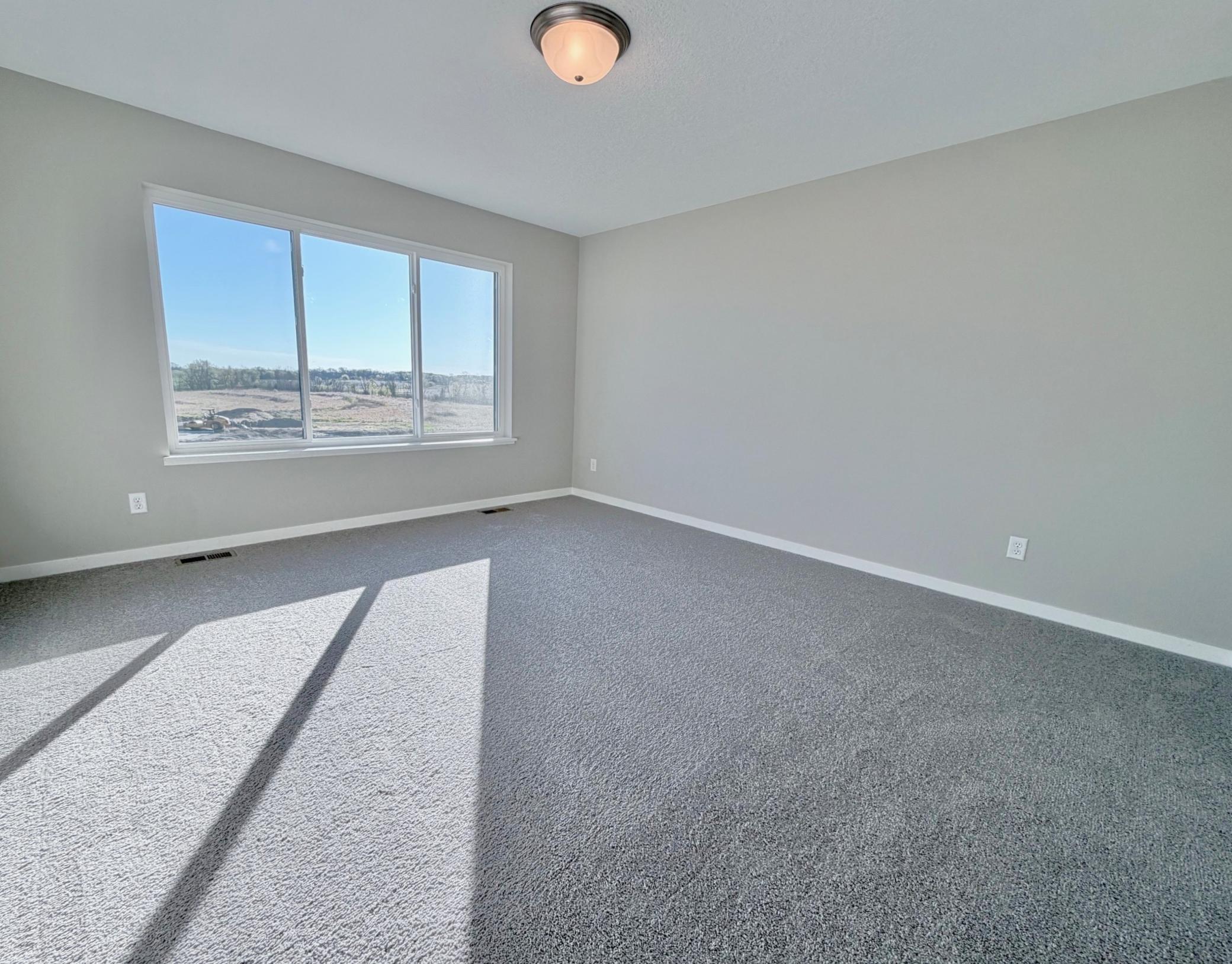 PHOTO OF A DIFFERENT HOME WITH SIMILAR PLAN. FINISHES MAY VARY. Primary Suite.