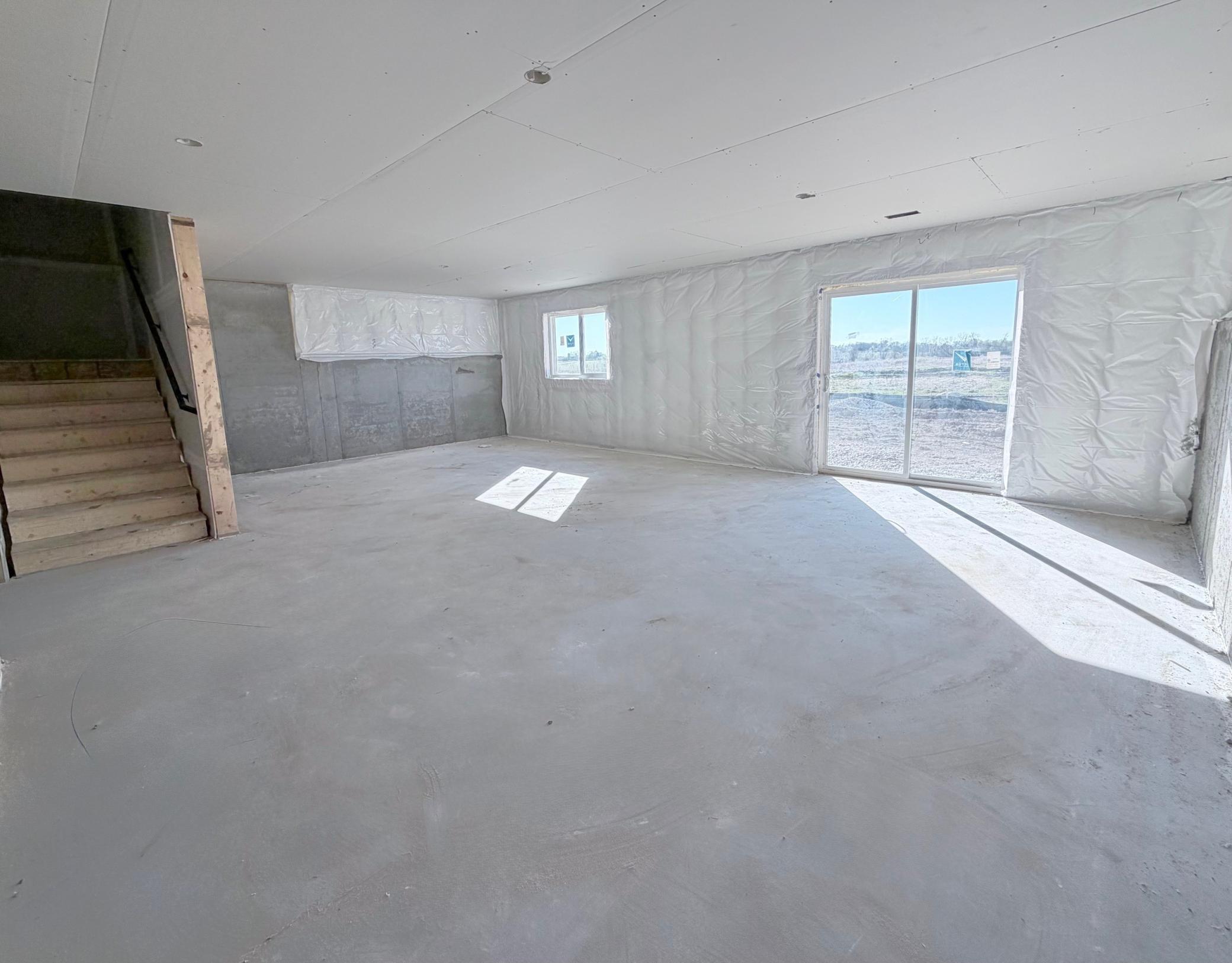 PHOTO OF A DIFFERENT HOME WITH SIMILAR PLAN. FINISHES MAY VARY. Unfinished Walkout Lower Level ready for future finish.
