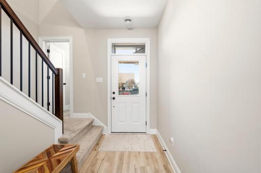 Bright entryway, staircase, and neutral finishes