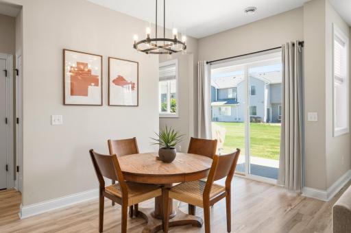 Dining area with patio door access and backyard views