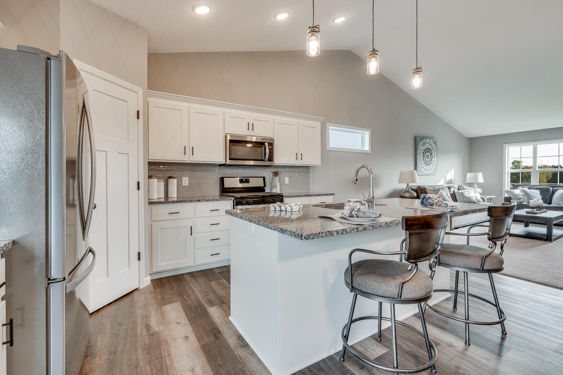 Photos are of a like home in different location. Options may be different in actual home. Actual home has no stone on the front.