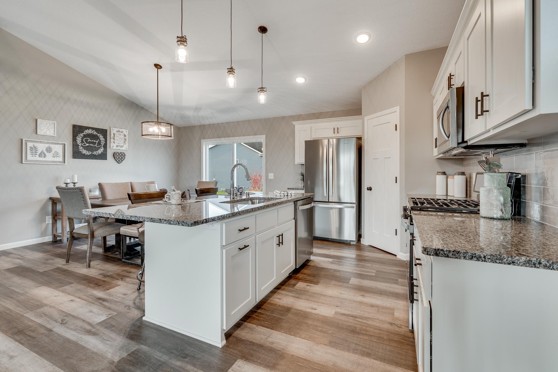 Photos are of a like home in different location. Options may be different in actual home. Actual home has no stone on the front.
