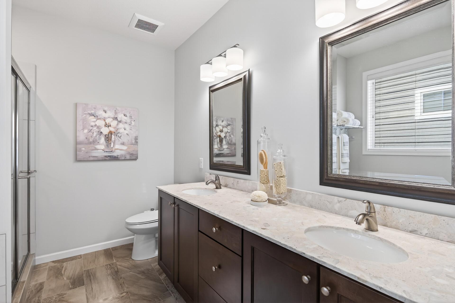Primary bathroom hosts double sinks