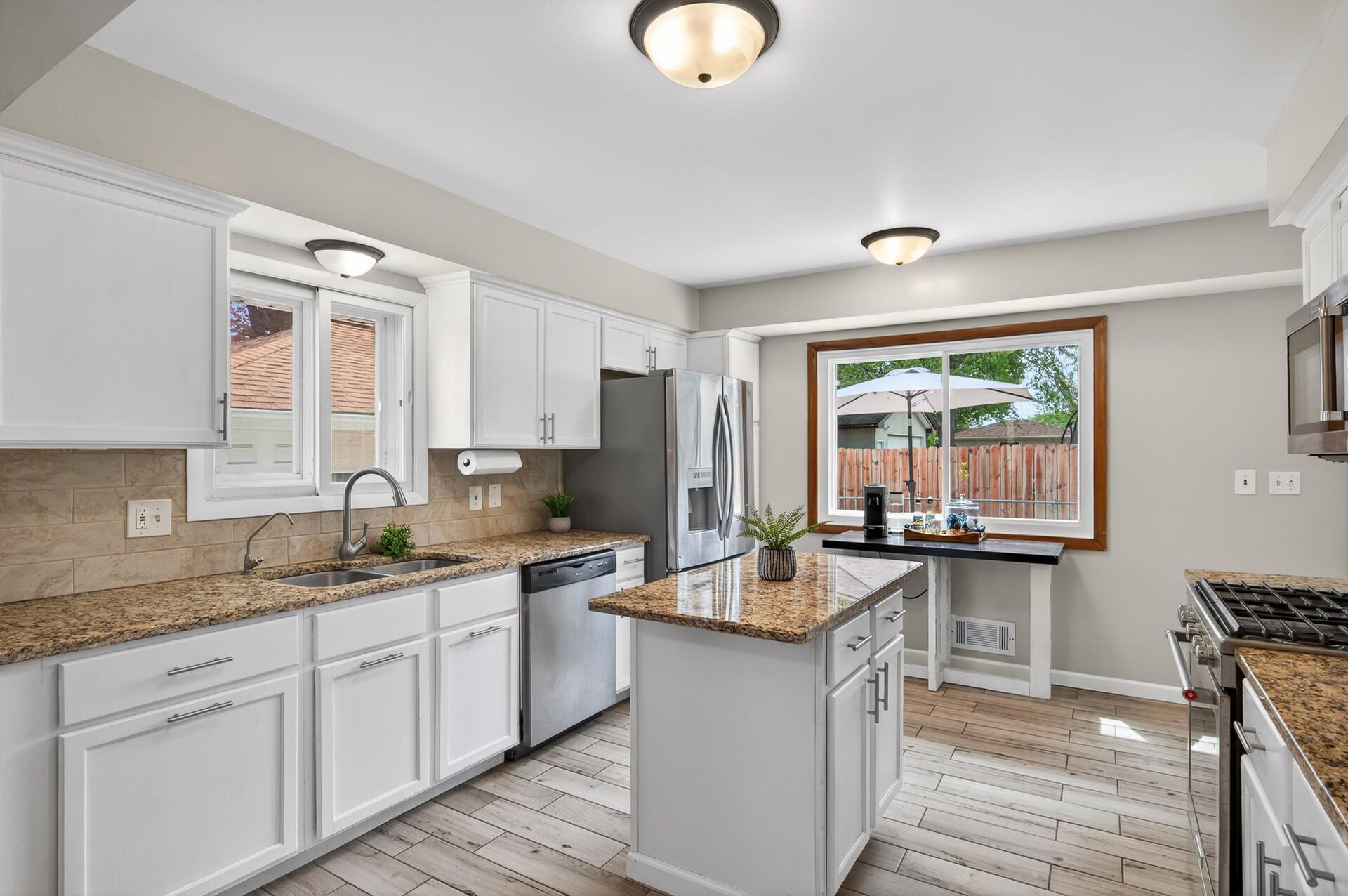 Kitchen with Granite Countertops, Tiled Floors, SS Appliances