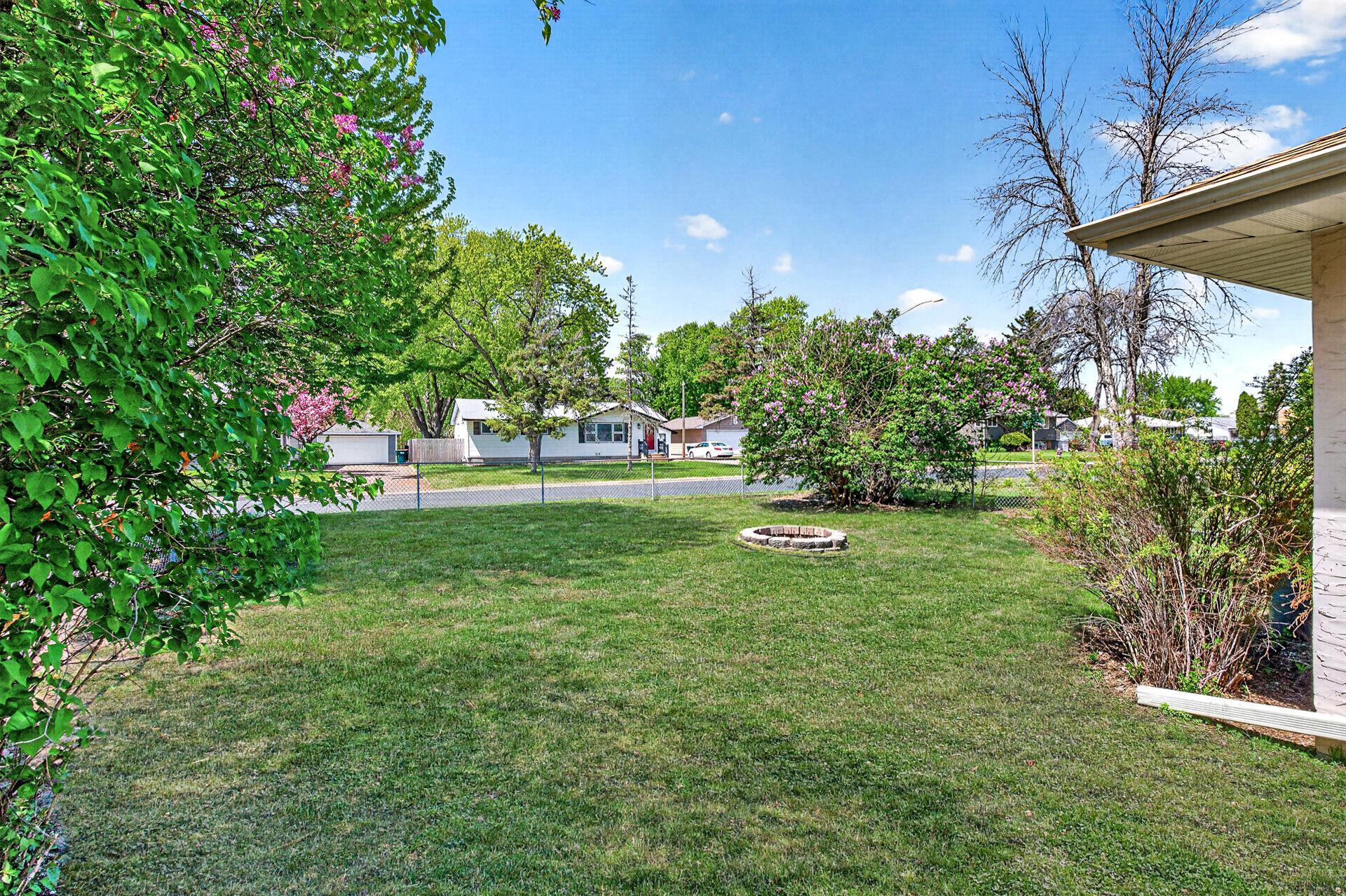 Chainlink Fenced Yard & Firepit on a Large Corner Lot - virtually enhanced