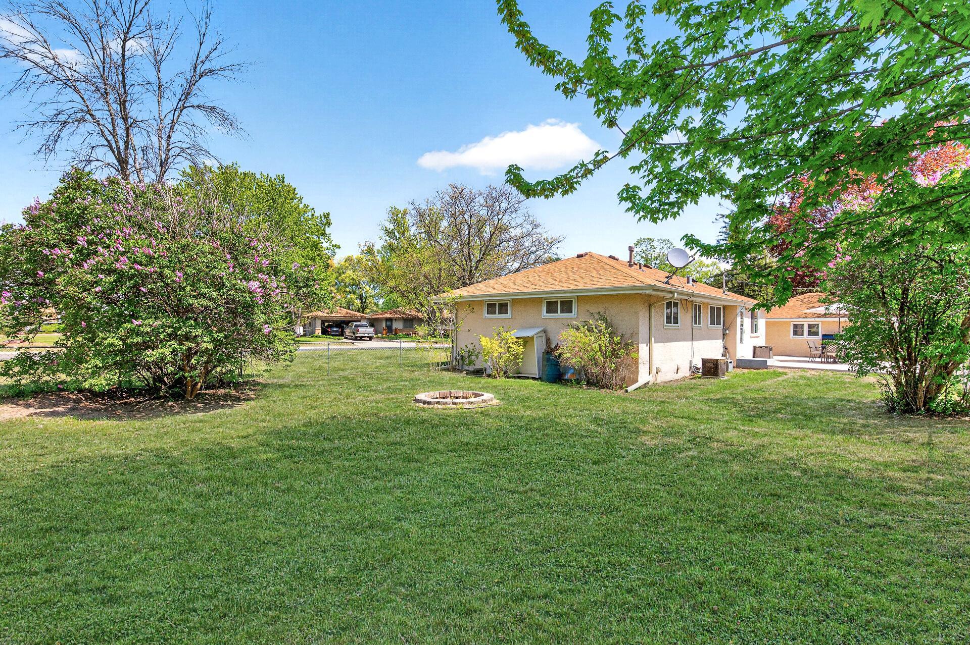 Corner View of Large Lot with Firepit - virtually enhanced