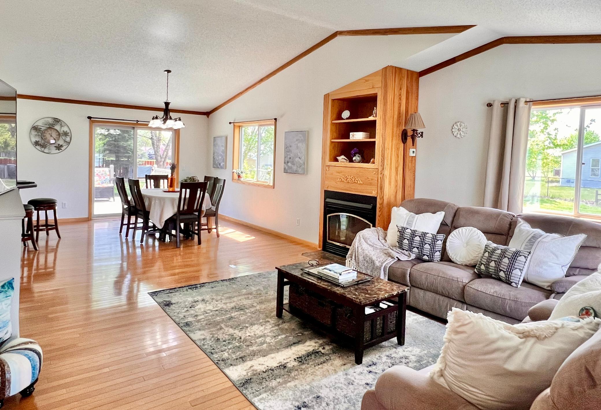 Hardwood floors and plentiful light create a bright, inviting dining and living space.