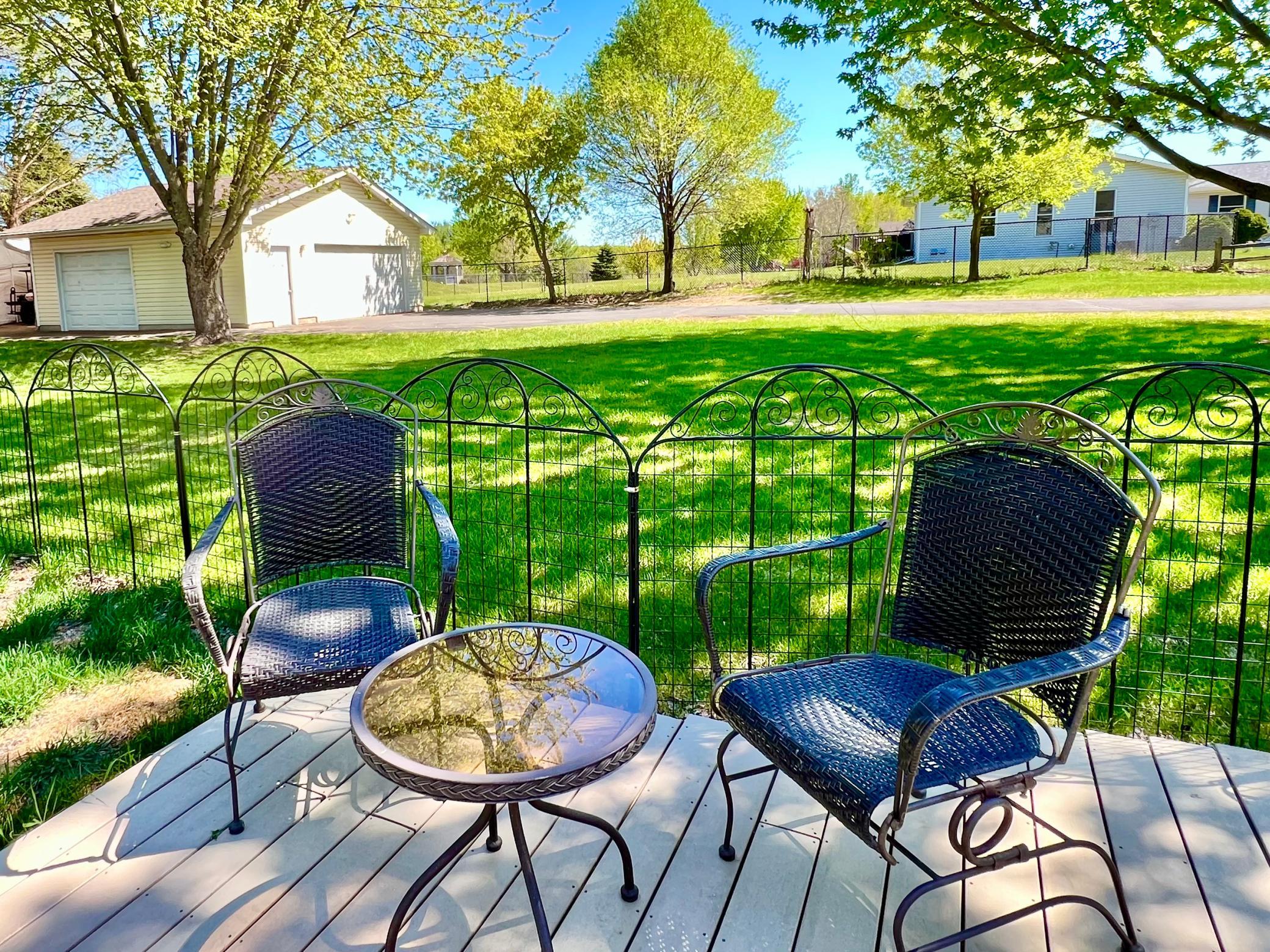 A firepit just to the left and massive carport behind detached garage.
