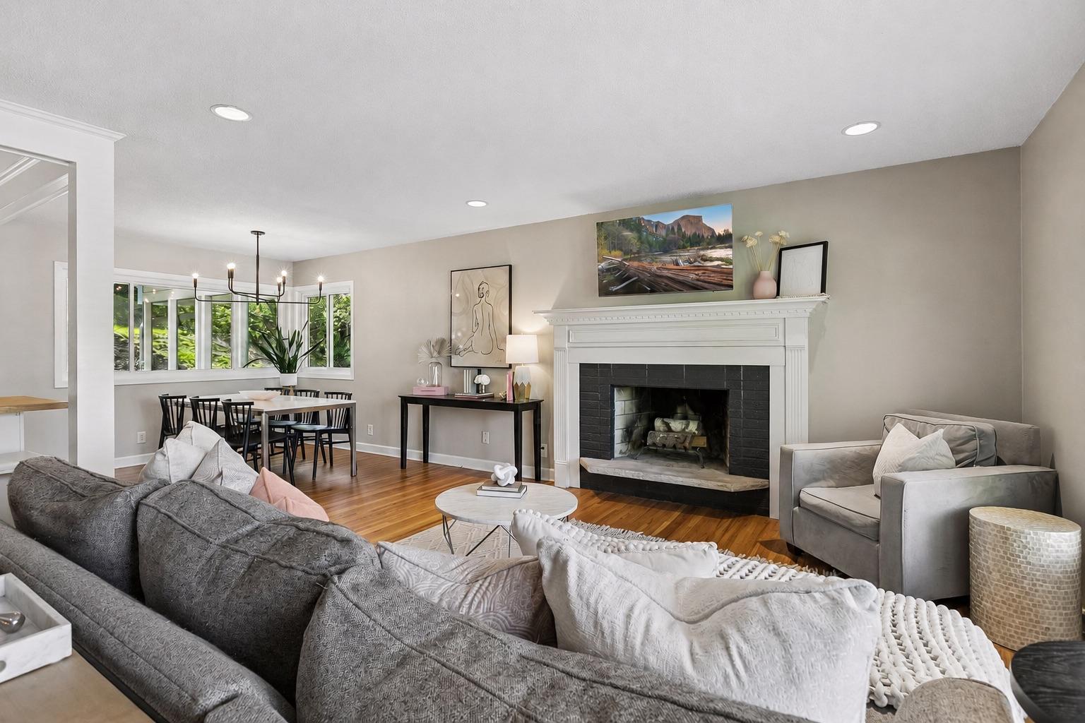 Refined yet comfortable, with recessed lighting, classic hardwood flooring, and a cozy fireplace.