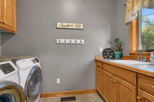 Finished main floor laundry room with a utility sink.