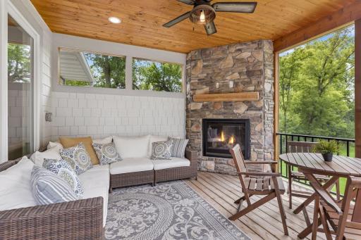 Screen porch with fireplace next to living room