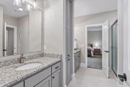Primary double vanity in walk thru bath with heated flooring