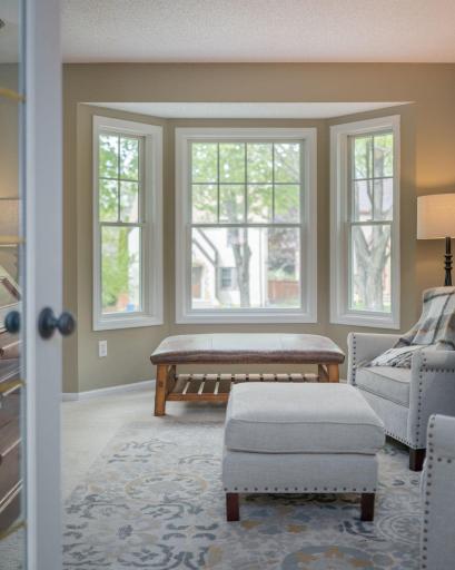 The bay window alcove offers the perfect reading nook or sitting area, bathed in natural light with beautiful views of the south view designed grounds beyond.