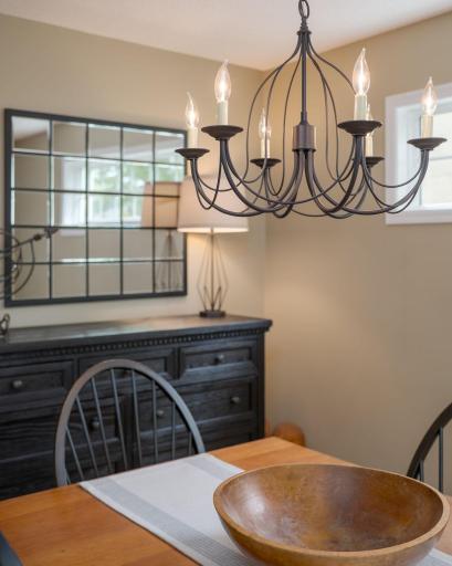 A dramatic wrought iron chandelier, a statement grid mirror, and rich dark furnishings: this dining room details what a true Highland Park home can feel like. Beautifully curated and completely livable.